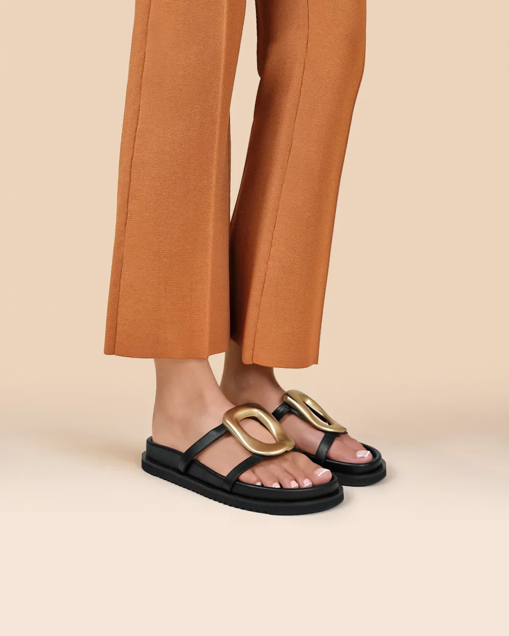 Milos Black Flat Sandals in black leather, gold ornament and chunky outsole